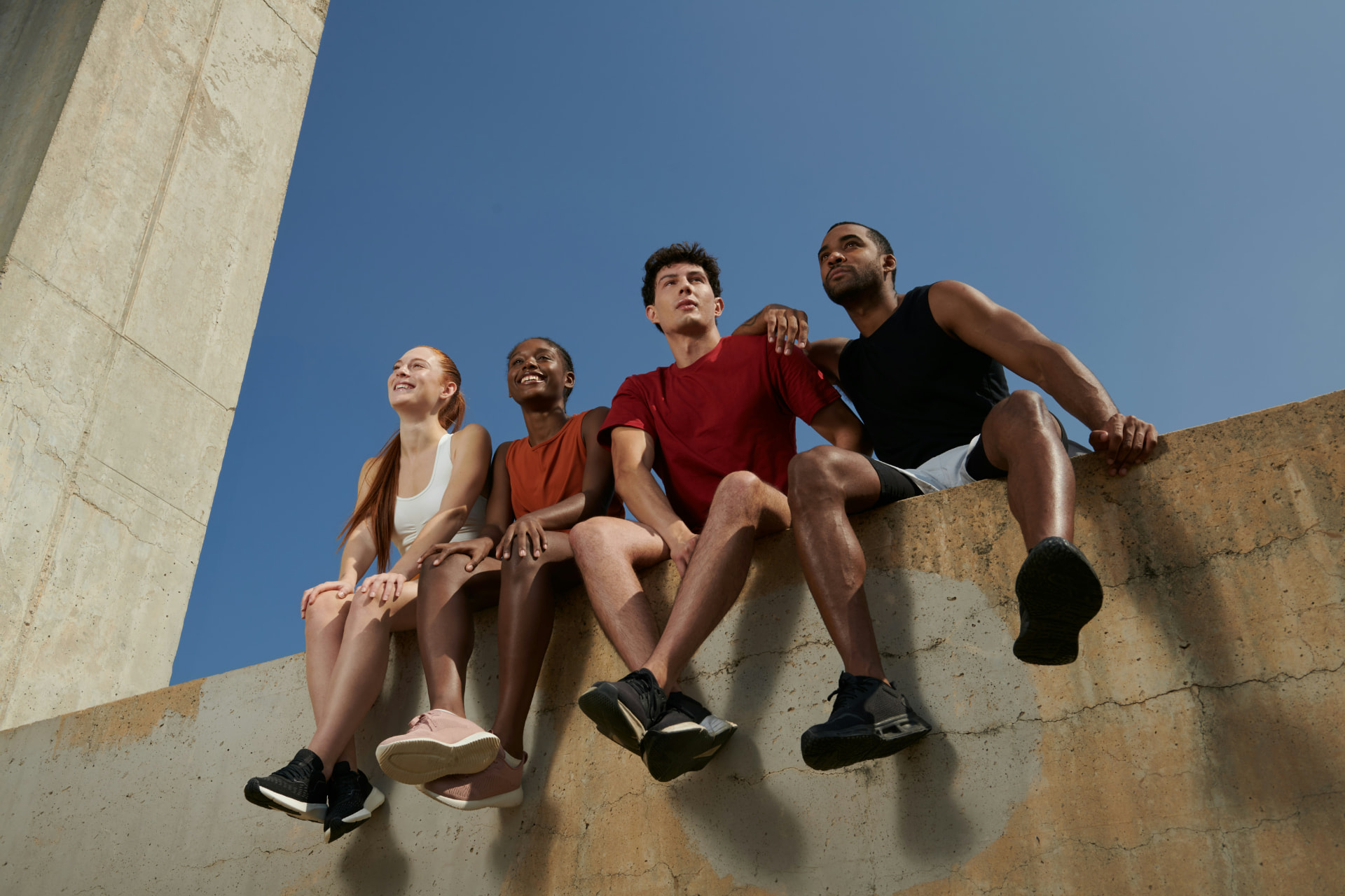 A smiling group of fitness friends running together outdoors