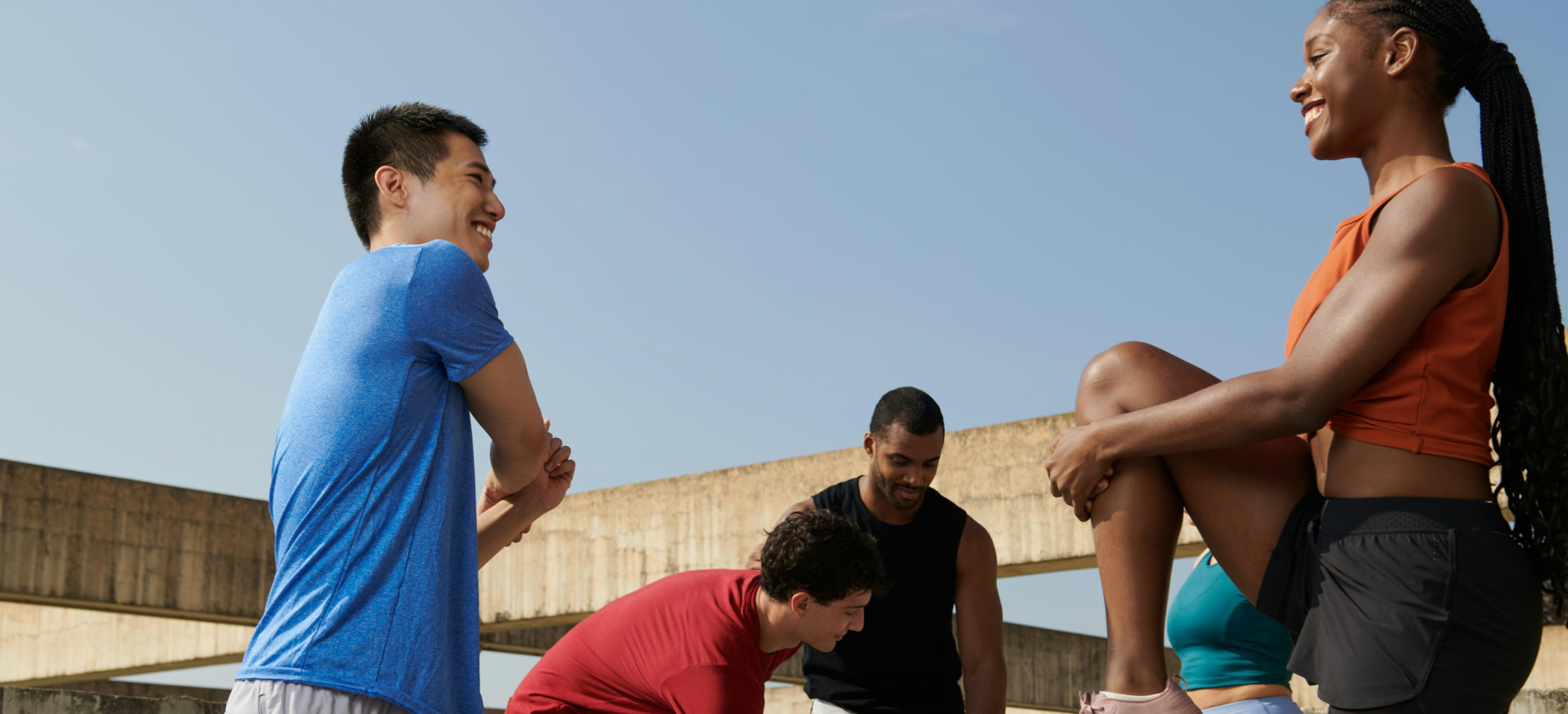 A group of fitness instructors talking outdoors after training